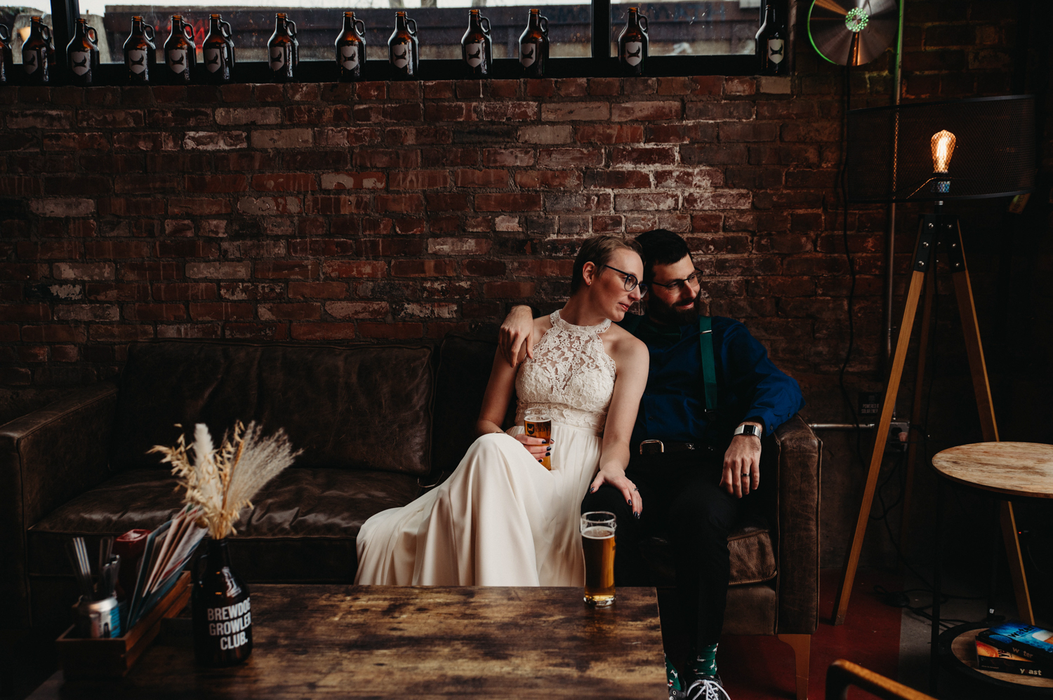 Couple cuddle at Brewdog Brewery in Cleveland on their wedding.