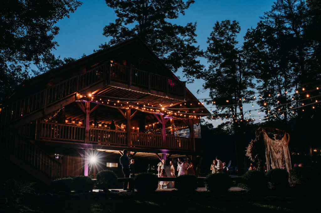 Mohican wedding venue at night while reception plays on.
