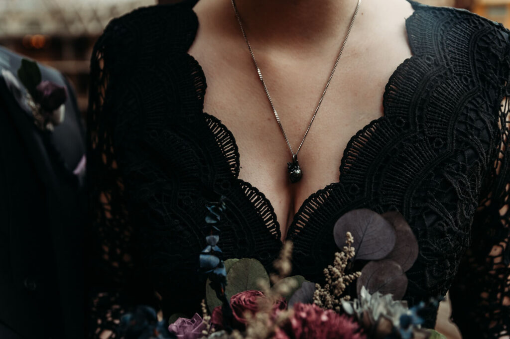 Black wedding dress in Ohio paired with a black heart necklace.