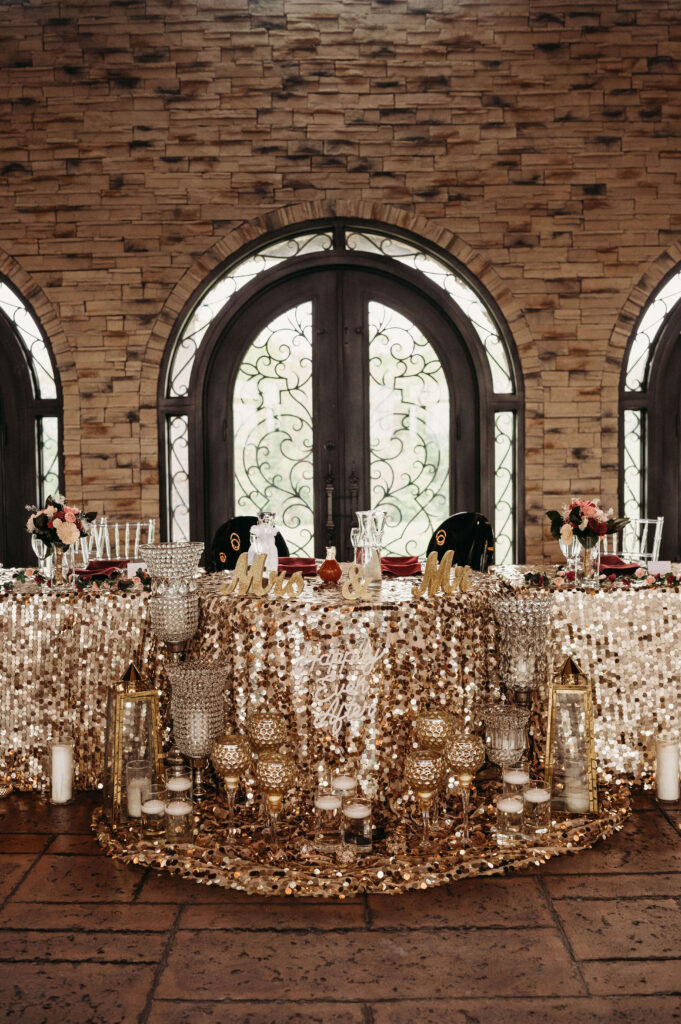 Sweetheart table at reception hall, gold and classic.