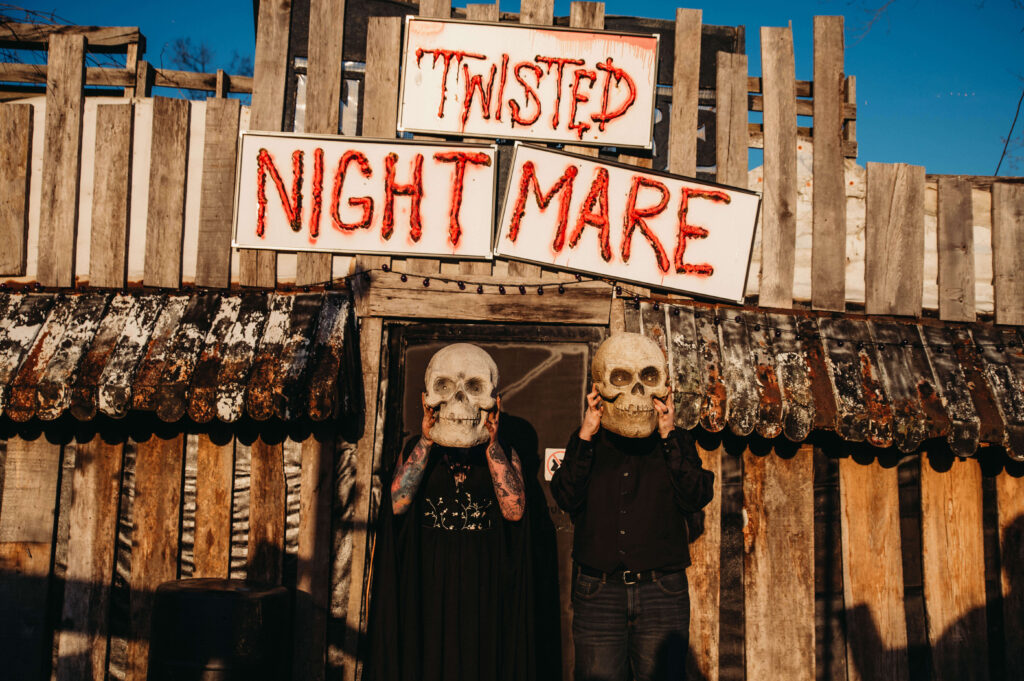 Haunted house attraction photo at Lake Shawnee with couple holding skulls as heads.