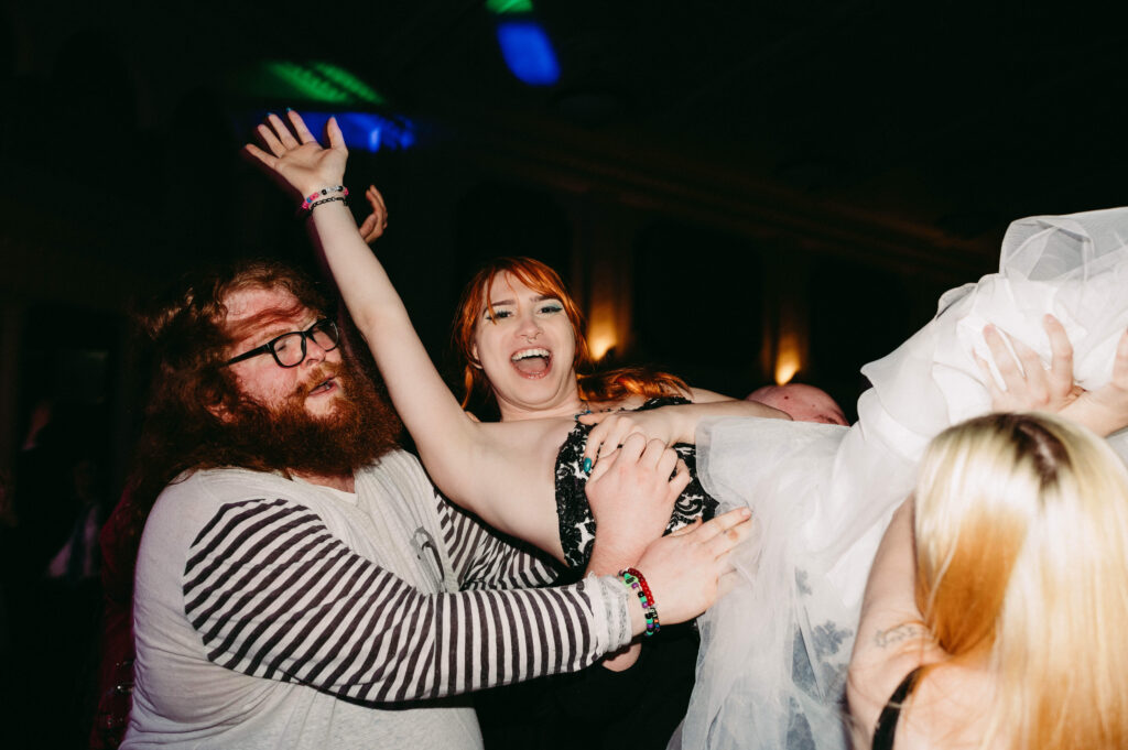 Alex crowdsurfs while a punk band performs on their wedding day.