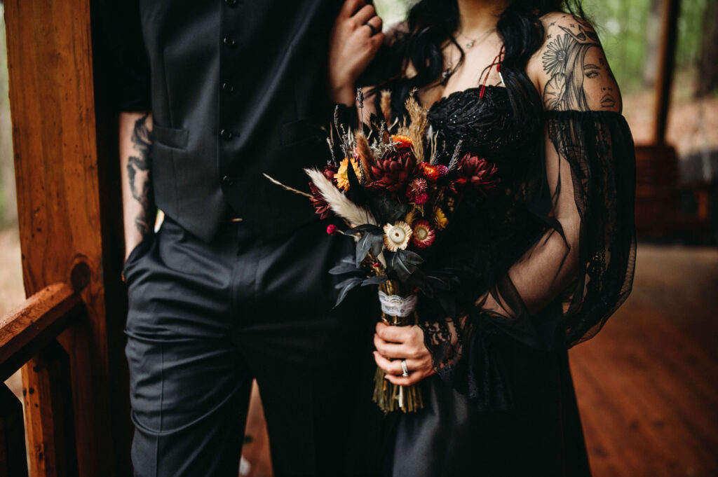 Black wedding dress and all black suit fit this gothic couple on Beltane renewal.
