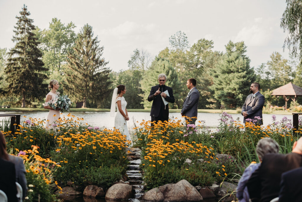 Intimate ceremony in front of wildflowers.