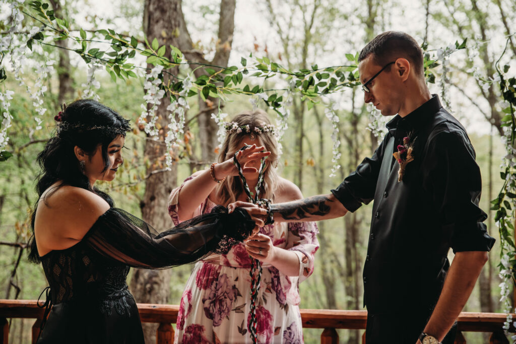 Hand fasting ceremony for witchy vow renewal in Salem.