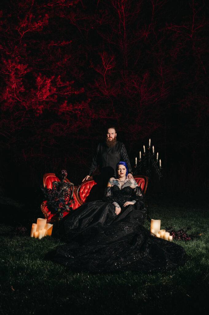 Gothic wedding couple take dramatic portrait at night in Salem.