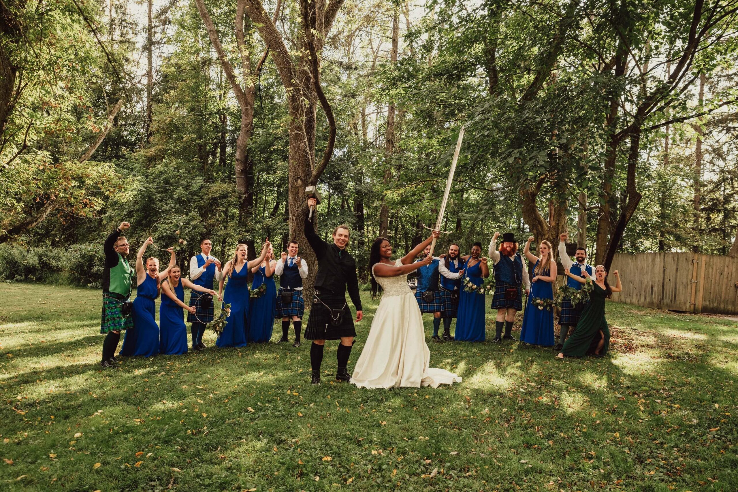 Wedding party celebrates marriage of friends with swords, hammers and good vibes at Renaissance Festival.
