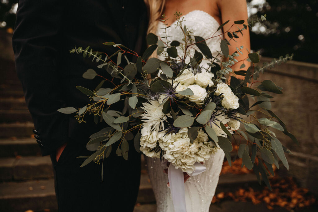 Simple white and green flowers create a stunning bouquet for this greenhouse wedding.