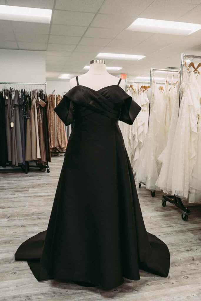 Plus size options in black wedding attire at bridal store.