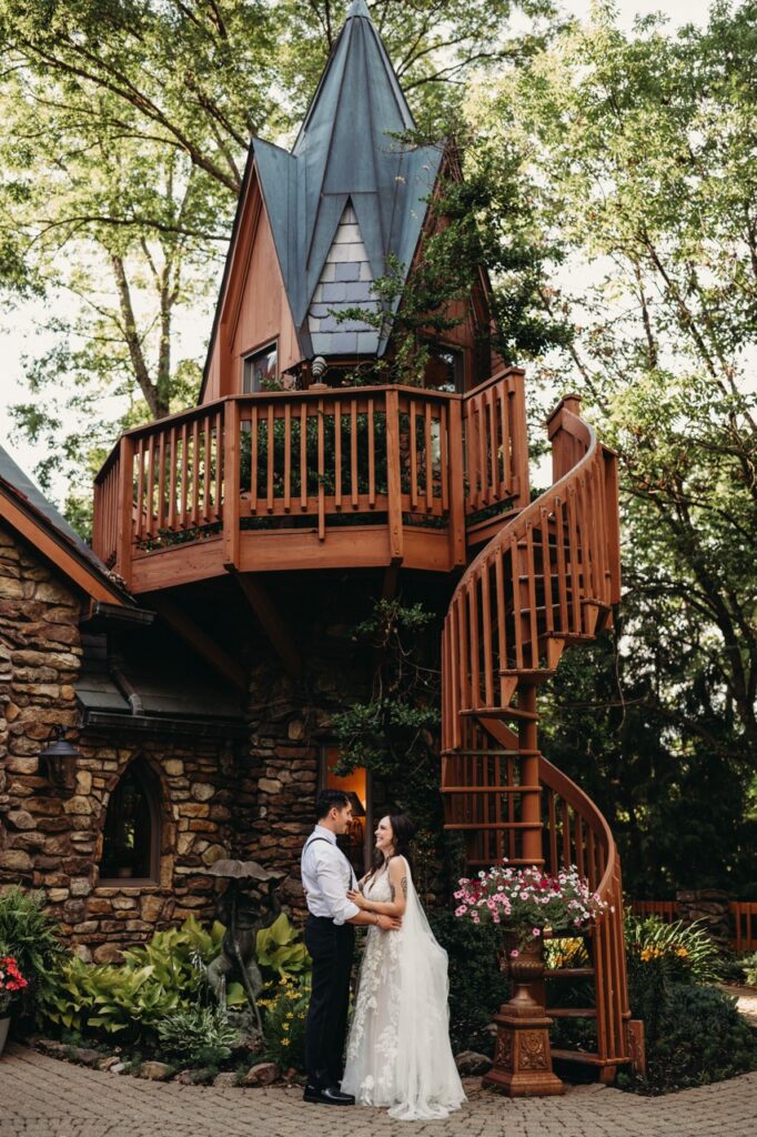 Couple stand outside hotel castle in Mohican