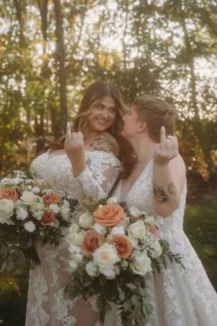 Brides show off their ring in an off beat pose, with vintage aesthetic and fall colors.