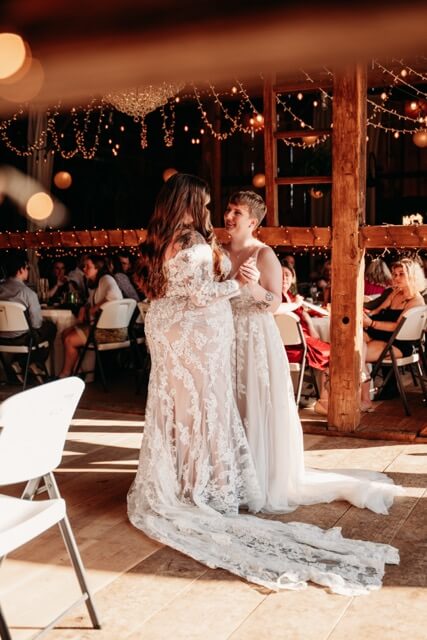 Beautifully lit barn gives cottage vibes for fall wedding for same sex couple.