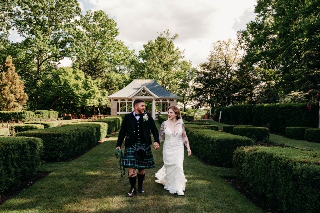 Couple walk away from ceremony at Gardens in Youngstown