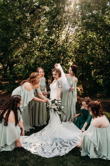 Wedding Party help Bride with final touches in Garden