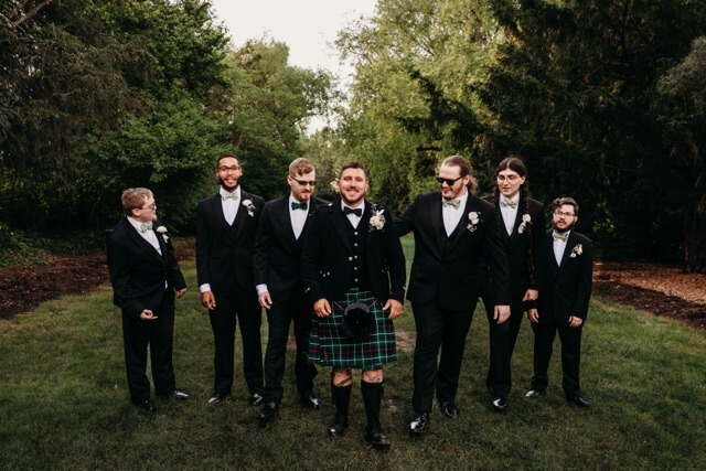 Groom and friends walk along Fellows Riverside path