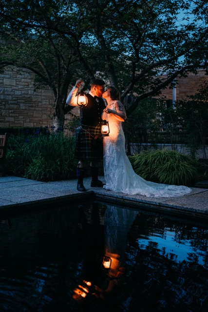Night photo of married couple during reception with moody lighting