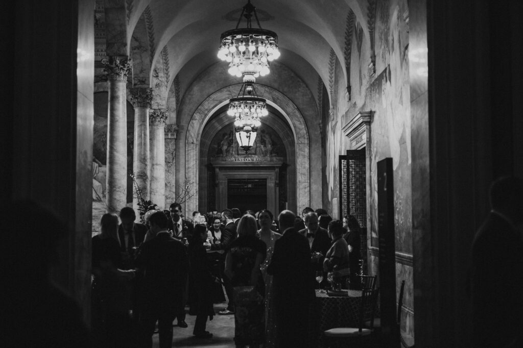 Cocktail hour in library at Boston wedding venue.